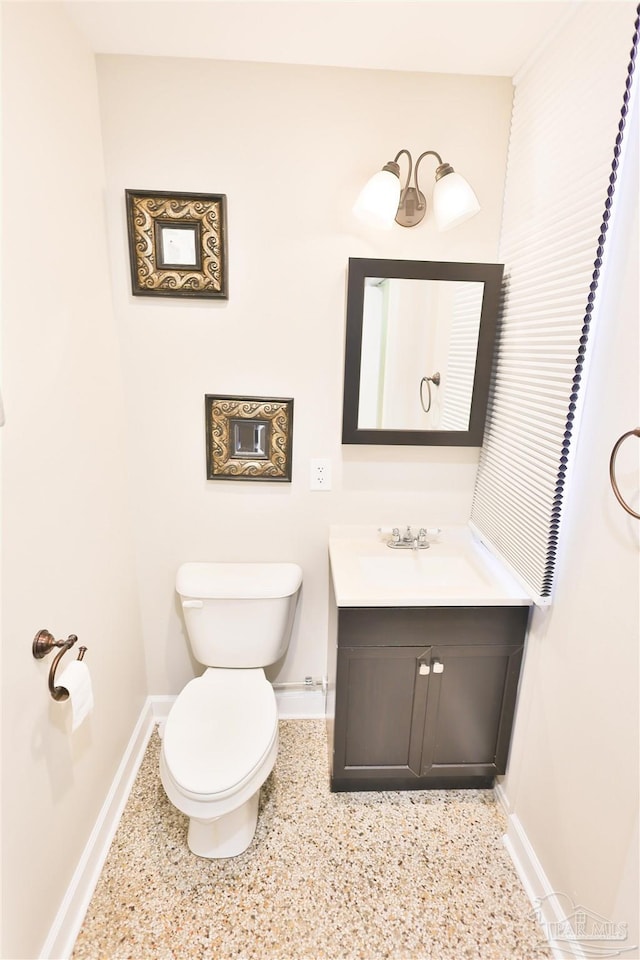 bathroom with toilet and vanity