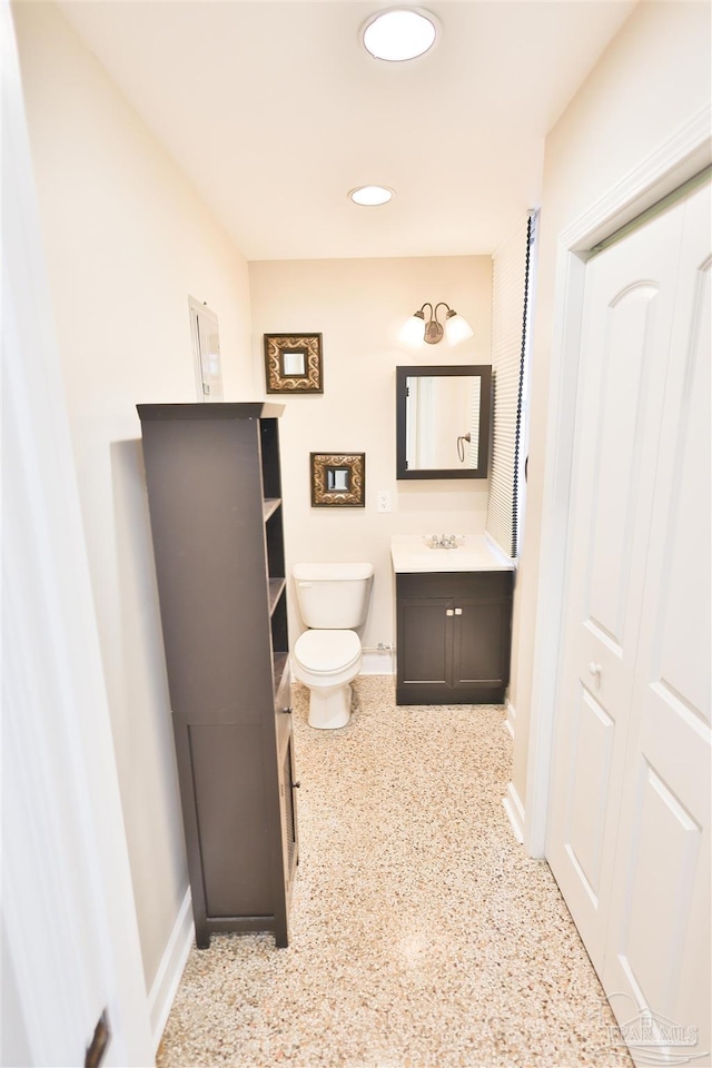 bathroom featuring vanity and toilet