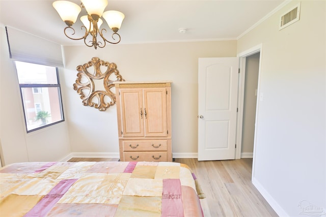 bedroom featuring light hardwood / wood-style floors, an inviting chandelier, and ornamental molding