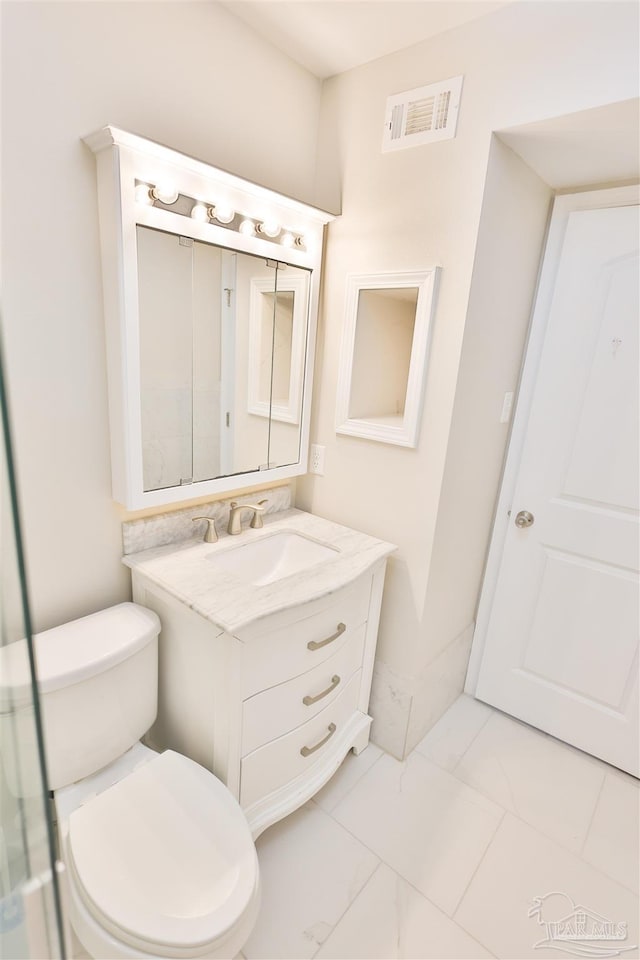 bathroom featuring vanity and toilet