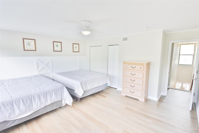 bedroom with ceiling fan, light hardwood / wood-style floors, and crown molding