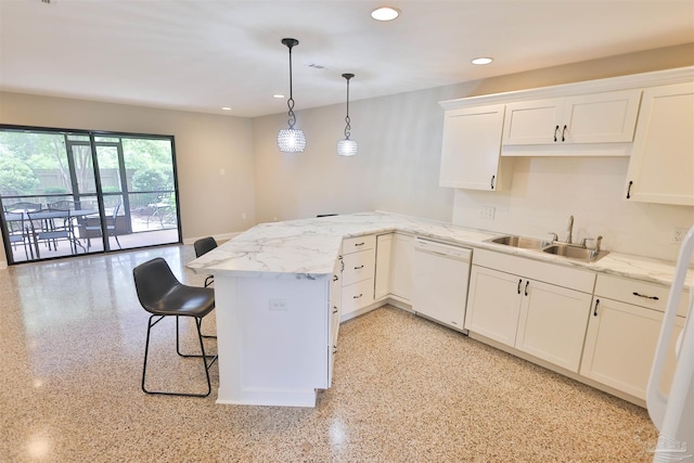 kitchen featuring dishwasher, kitchen peninsula, decorative light fixtures, and a breakfast bar