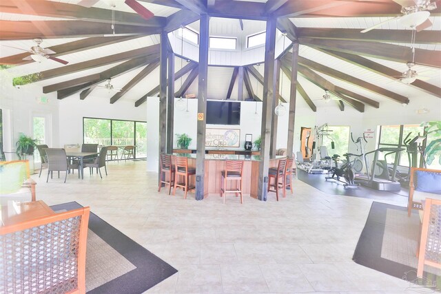 interior space with beamed ceiling, ceiling fan, and high vaulted ceiling