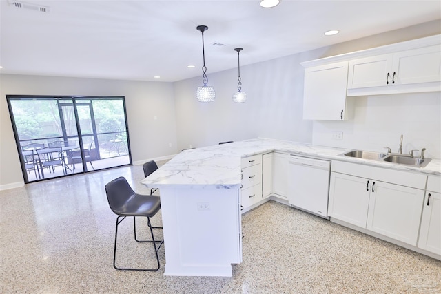 kitchen featuring white cabinetry, kitchen peninsula, a breakfast bar, sink, and white dishwasher