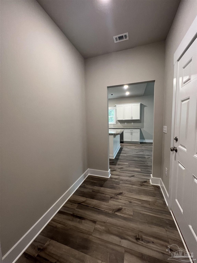 hallway with dark wood-type flooring