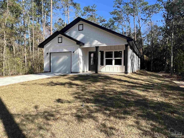 modern farmhouse style home with a front yard and a garage