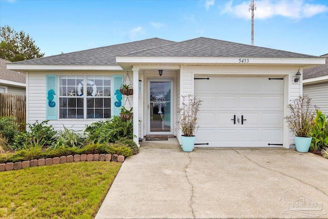 single story home featuring a front lawn and a garage