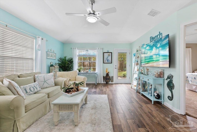 living room featuring ceiling fan and dark hardwood / wood-style floors