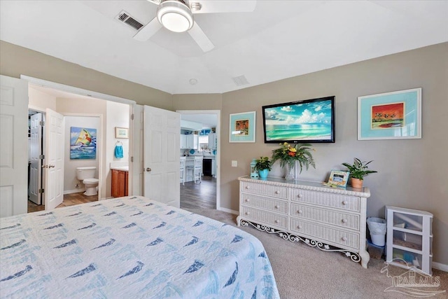 carpeted bedroom with connected bathroom and ceiling fan