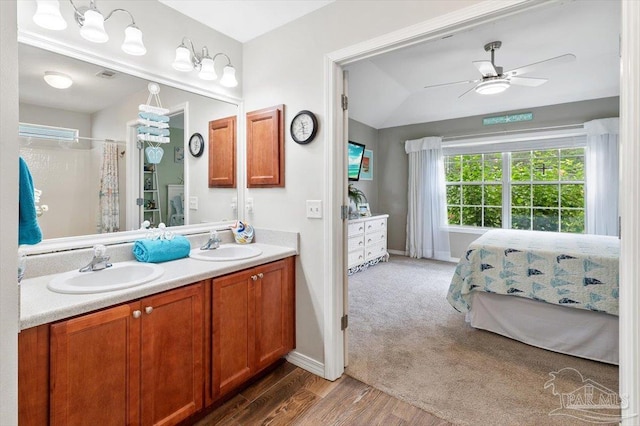 bathroom featuring wood-type flooring, vanity, and ceiling fan