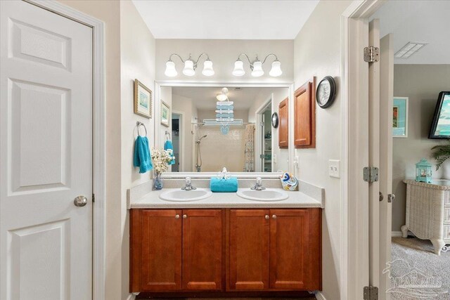 bathroom with vanity and a shower with door