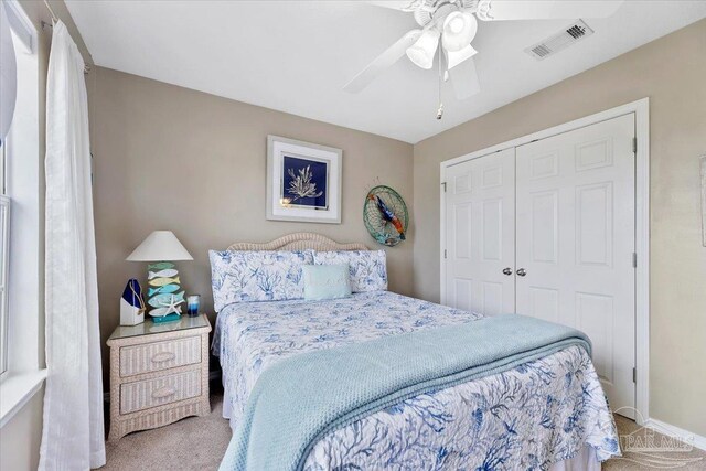 carpeted bedroom with a closet and ceiling fan