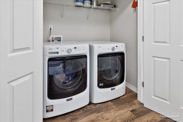 laundry room with independent washer and dryer and dark hardwood / wood-style flooring