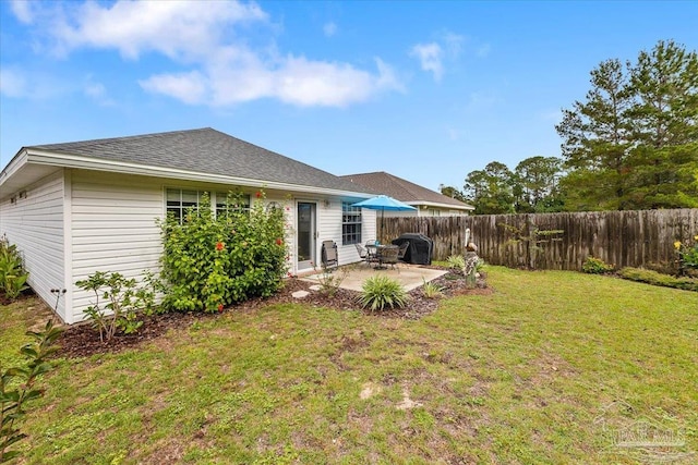 back of property featuring a lawn and a patio area