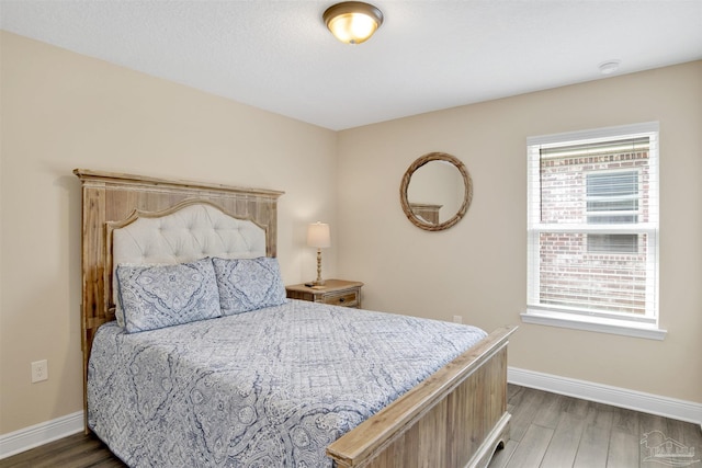 2956 N 17th Ave, Milton, FL 32583 - bedroom with multiple windows, baseboards, and wood finished floors