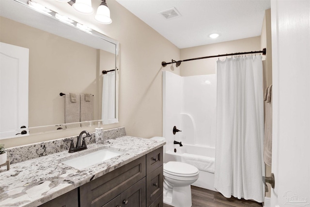 2956 N 17th Ave, Milton, FL 32583 - full bath with wood finished floors, vanity, shower / tub combo, and toilet