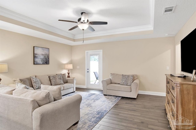 2956 N 17th Ave, Milton, FL 32583 - living room with a raised ceiling, dark wood-style flooring, ornamental molding, ceiling fan, and baseboards