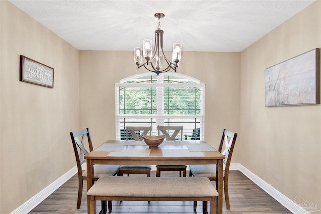 2956 N 17th Ave, Milton, FL 32583 - dining room with a chandelier, wood finished floors, and baseboards