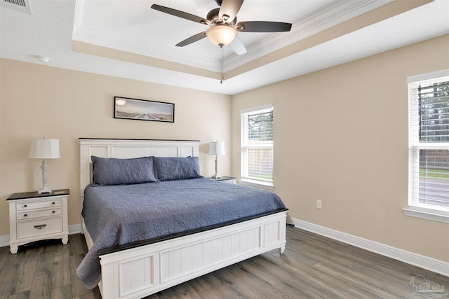 2956 N 17th Ave, Milton, FL 32583 - bedroom featuring a tray ceiling, dark wood finished floors, multiple windows, and crown molding