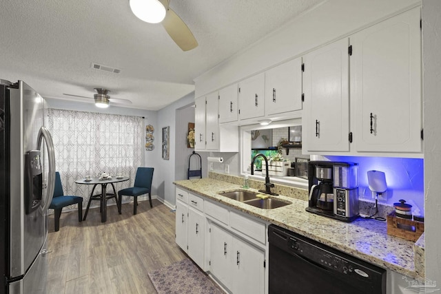 kitchen with sink, white cabinetry, black dishwasher, light stone countertops, and stainless steel fridge with ice dispenser