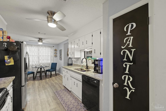 kitchen featuring white cabinetry, sink, light wood-type flooring, and appliances with stainless steel finishes