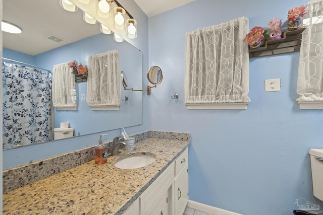 bathroom with vanity, a shower with curtain, and toilet