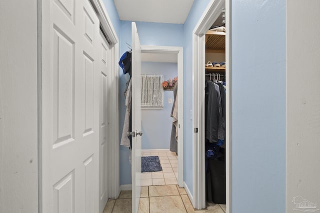 hallway featuring light tile patterned floors