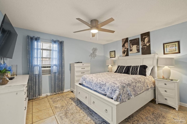 tiled bedroom with ceiling fan and a textured ceiling