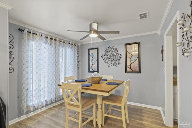 dining area featuring hardwood / wood-style flooring, ceiling fan, and ornamental molding