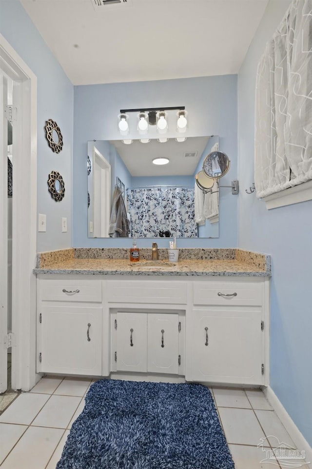 bathroom featuring tile patterned flooring and vanity