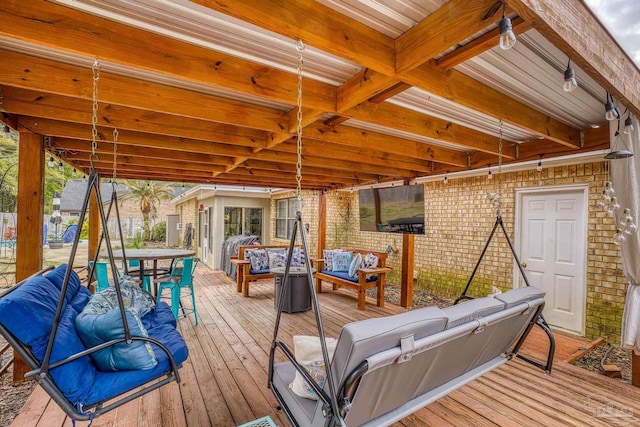 wooden terrace with an outdoor living space