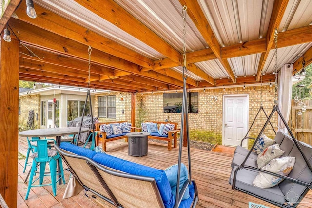 wooden terrace featuring an outdoor living space with a fire pit