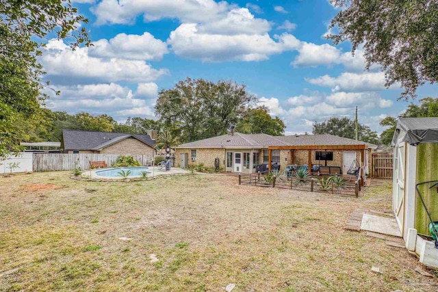 view of yard featuring a fenced in pool and a patio