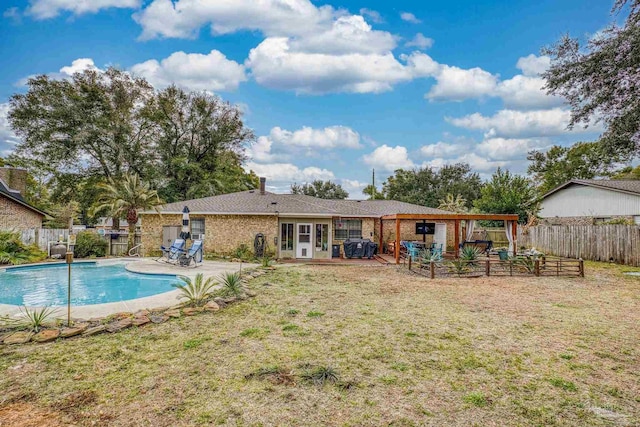 view of swimming pool featuring a patio and a yard