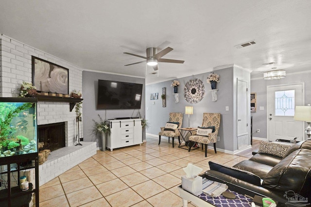 living room featuring light tile patterned flooring, ornamental molding, ceiling fan, and a fireplace