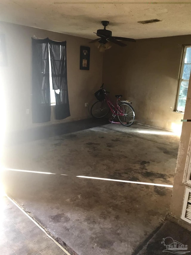 interior space with ceiling fan