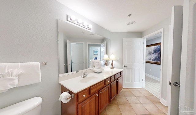 931 W Beach Blvd Unit 501, Gulf Shores, AL 36542 - bathroom featuring vanity, tile patterned flooring, toilet, and baseboards