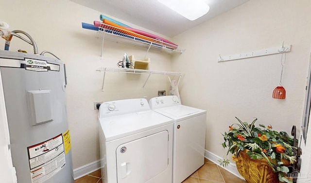 931 W Beach Blvd Unit 501, Gulf Shores, AL 36542 - laundry room with water heater, washing machine and dryer, light tile patterned floors, and baseboards