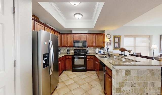 931 W Beach Blvd Unit 501, Gulf Shores, AL 36542 - kitchen with black appliances, a sink, a peninsula, backsplash, and light stone counters