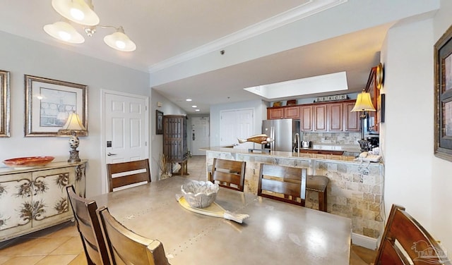 931 W Beach Blvd Unit 501, Gulf Shores, AL 36542 - dining room with ornamental molding and light tile patterned floors