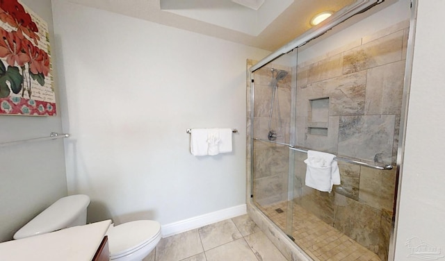 931 W Beach Blvd Unit 501, Gulf Shores, AL 36542 - bathroom featuring toilet, a stall shower, vanity, and baseboards