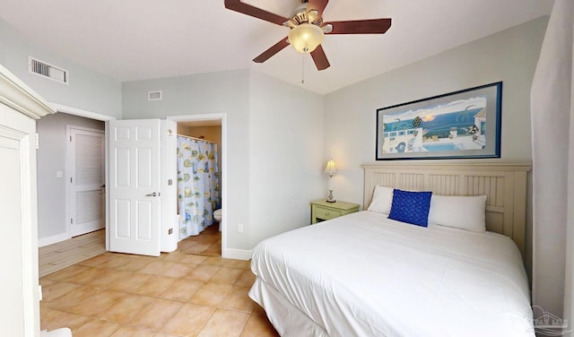 931 W Beach Blvd Unit 501, Gulf Shores, AL 36542 - bedroom featuring light tile patterned flooring, baseboards, ceiling fan, and ensuite bath