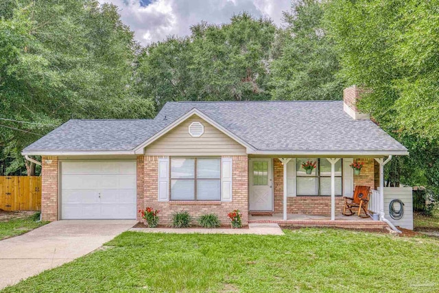 ranch-style house with covered porch, a garage, and a front lawn