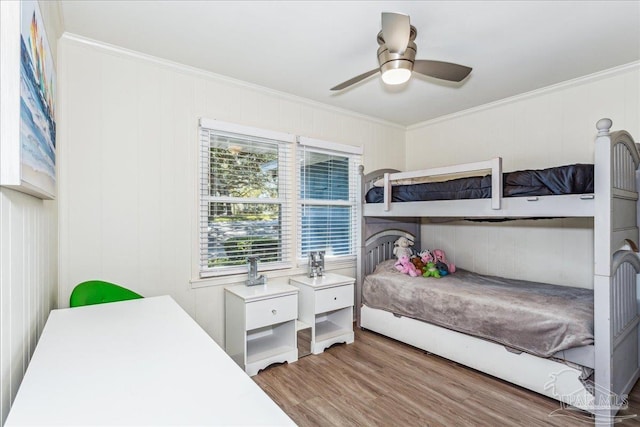 bedroom featuring ceiling fan, crown molding, and hardwood / wood-style floors