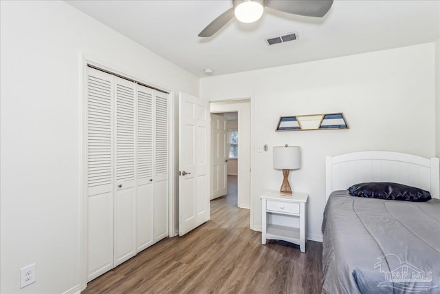 bedroom featuring ceiling fan, a closet, and dark hardwood / wood-style floors