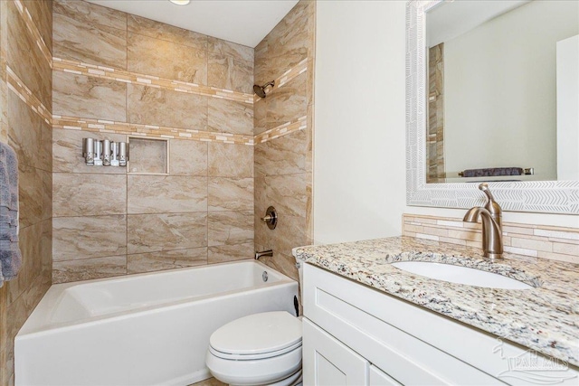 full bathroom with toilet, tiled shower / bath, backsplash, and vanity