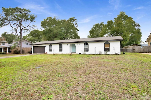 ranch-style house with a garage and a front yard