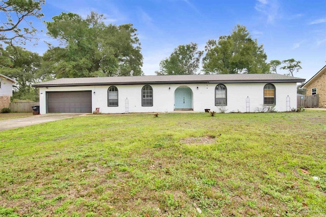 ranch-style home featuring a garage and a front lawn