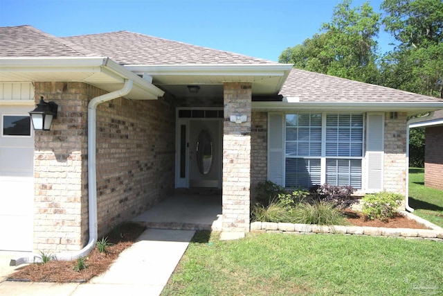doorway to property featuring an attached garage, roof with shingles, and brick siding
