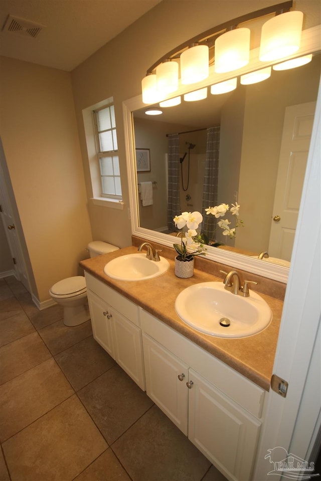 bathroom with tile patterned flooring, visible vents, a shower with curtain, and a sink